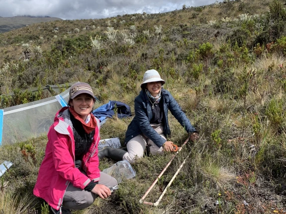 Two researchers look up from their sampling project.